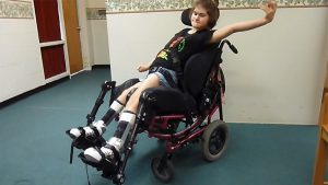 Young girl with cerebral palsy sitting in Dynamic Seating wheelchair