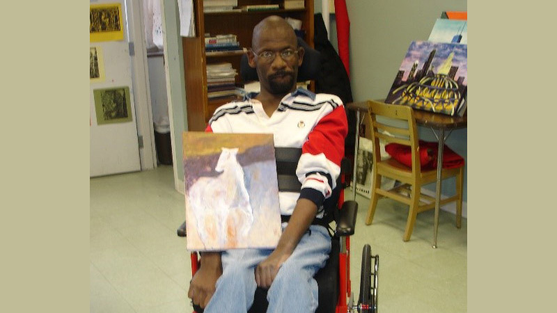 Derrick holding a painting